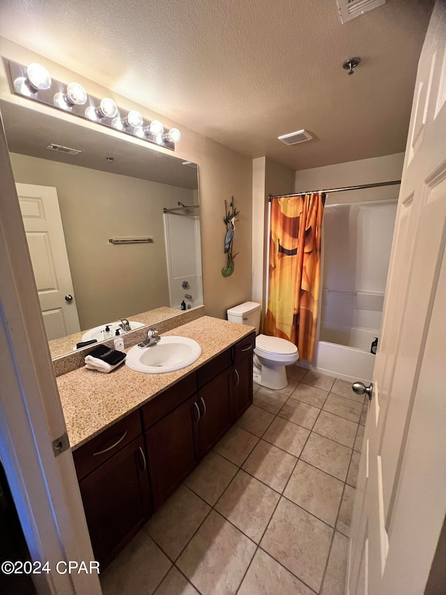 full bathroom featuring a textured ceiling, vanity, shower / tub combo, toilet, and tile patterned floors