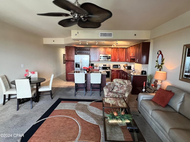 living room with light colored carpet and ceiling fan