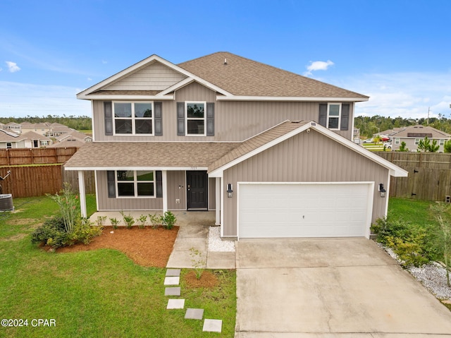 front of property with a garage, a front yard, and central air condition unit