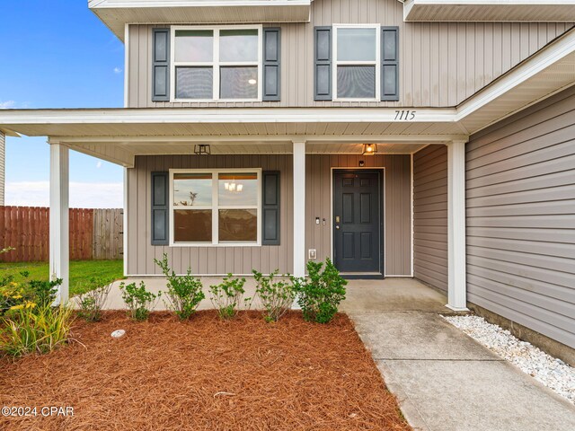 doorway to property featuring covered porch