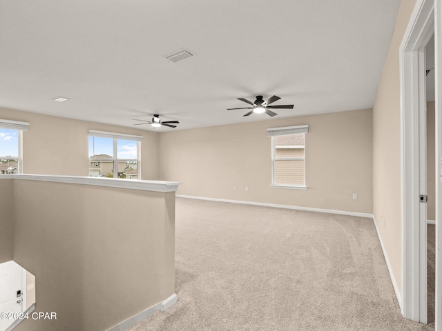 carpeted spare room with a wealth of natural light