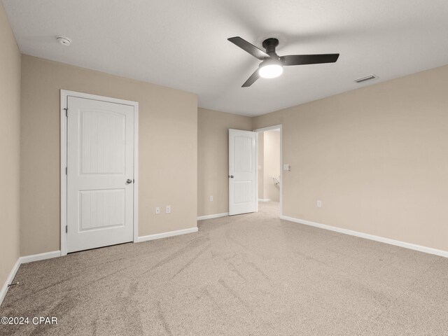 unfurnished bedroom with ceiling fan and carpet flooring