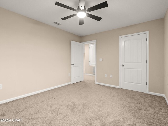 unfurnished bedroom featuring carpet flooring and ceiling fan