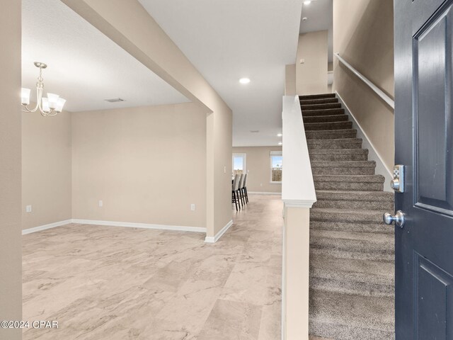 entrance foyer featuring a notable chandelier