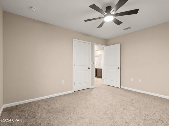 unfurnished bedroom featuring ceiling fan and carpet