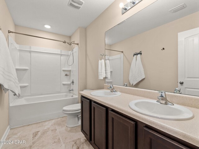 full bathroom with washtub / shower combination, vanity, and toilet