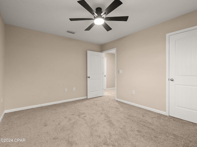 unfurnished bedroom with light carpet and ceiling fan