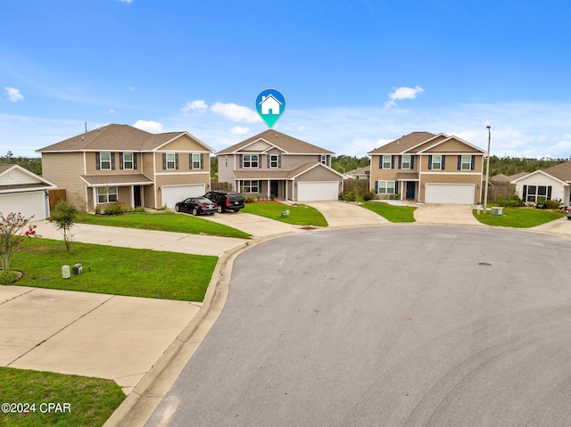 view of front of house featuring a garage and a front yard