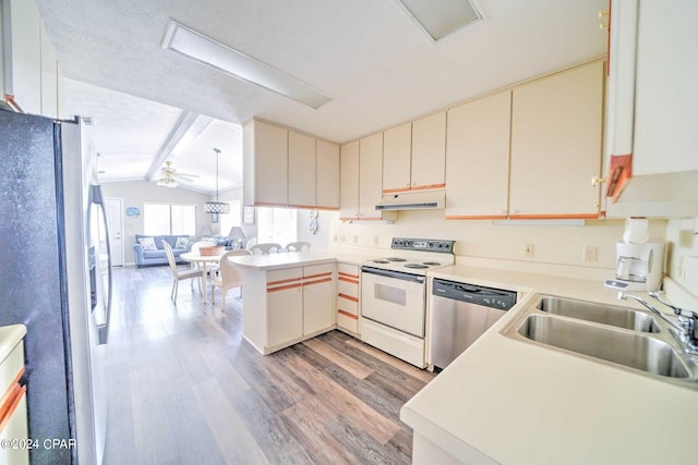 kitchen with lofted ceiling with beams, light wood-type flooring, sink, stainless steel appliances, and ceiling fan