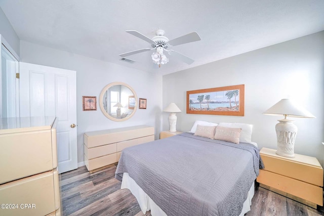 bedroom with ceiling fan and dark wood-type flooring