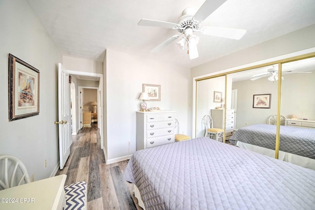 bedroom with ceiling fan, a textured ceiling, a closet, and wood-type flooring