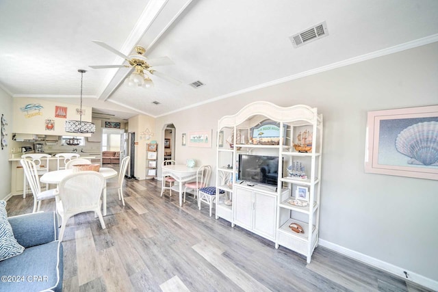 living room featuring wood-type flooring, vaulted ceiling with beams, ceiling fan, and crown molding