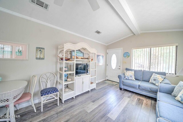 living room with vaulted ceiling with beams, wood-type flooring, crown molding, and ceiling fan