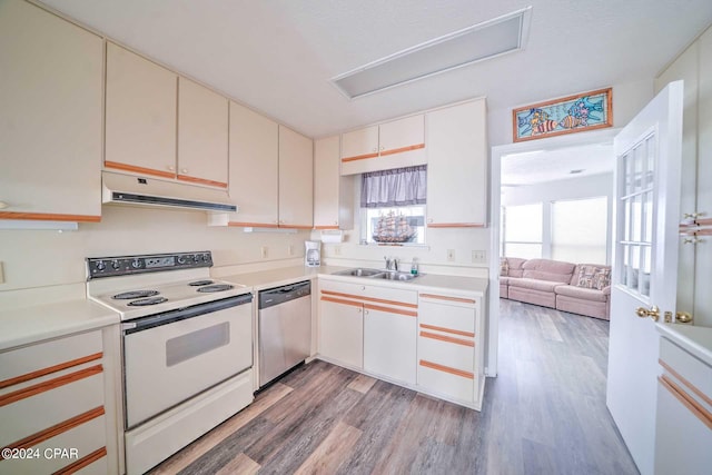 kitchen featuring white cabinets, white electric range oven, light hardwood / wood-style flooring, stainless steel dishwasher, and sink