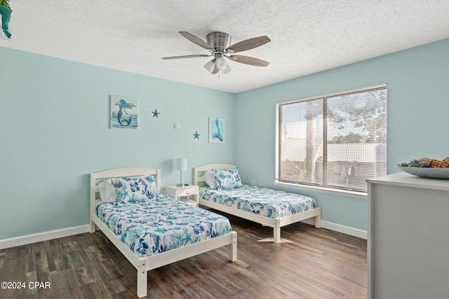 bedroom featuring a textured ceiling, dark hardwood / wood-style flooring, and ceiling fan