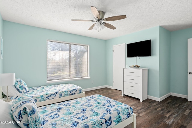 bedroom featuring ceiling fan, a textured ceiling, and dark wood-type flooring