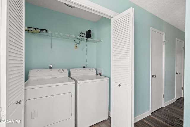 laundry room featuring separate washer and dryer, a textured ceiling, and dark hardwood / wood-style flooring