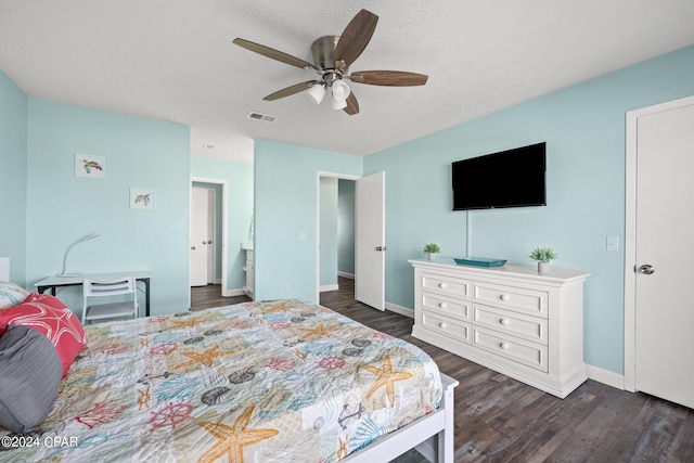 bedroom featuring ceiling fan, dark hardwood / wood-style floors, and a textured ceiling