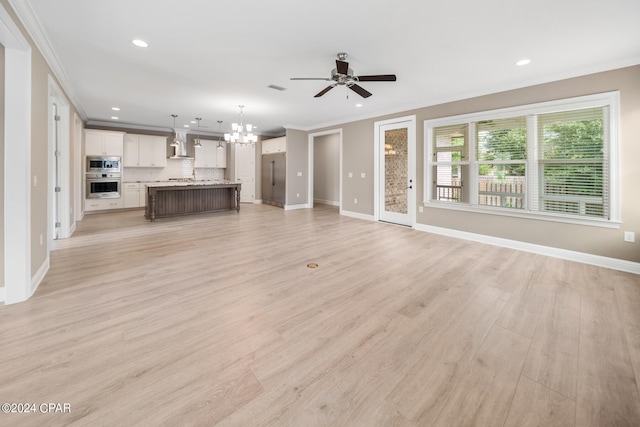 unfurnished living room with crown molding, ceiling fan with notable chandelier, and light wood-type flooring