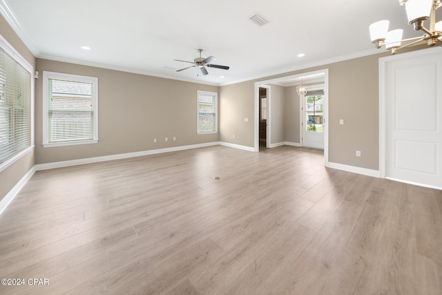 empty room featuring ceiling fan with notable chandelier, ornamental molding, and light hardwood / wood-style flooring