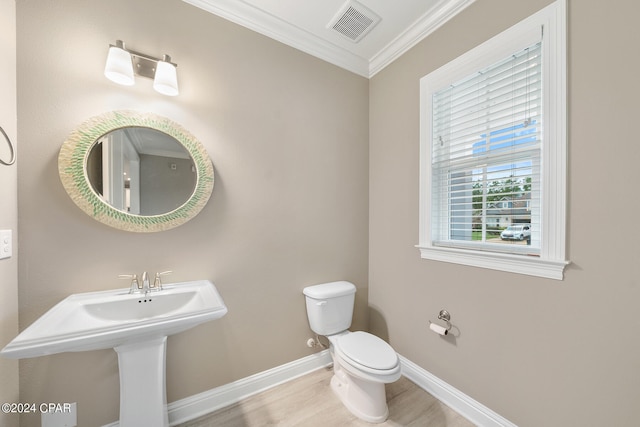 bathroom featuring toilet, hardwood / wood-style flooring, sink, and ornamental molding