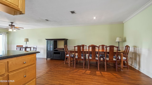 dining room featuring crown molding, ceiling fan, and dark hardwood / wood-style flooring