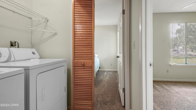 clothes washing area with separate washer and dryer and carpet floors