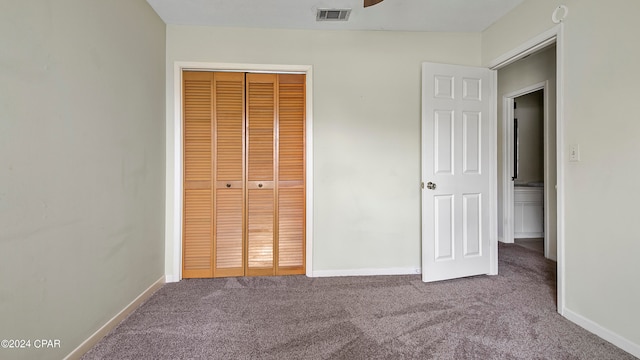 unfurnished bedroom with carpet floors and a closet