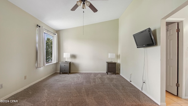 interior space with light carpet, vaulted ceiling, and ceiling fan