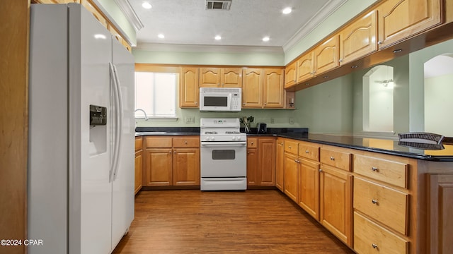 kitchen featuring ornamental molding, white appliances, a textured ceiling, dark hardwood / wood-style flooring, and kitchen peninsula