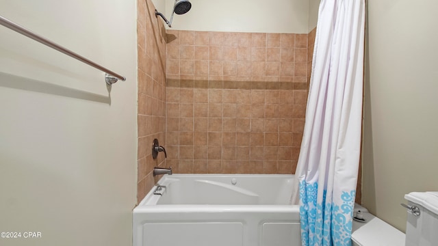 bathroom with toilet and shower / bath combo with shower curtain