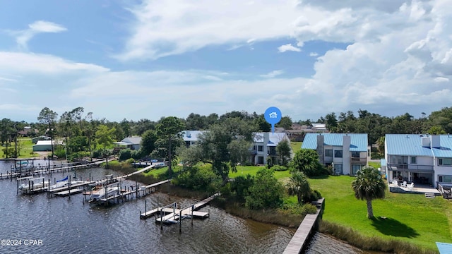 exterior space with a lawn and a water view