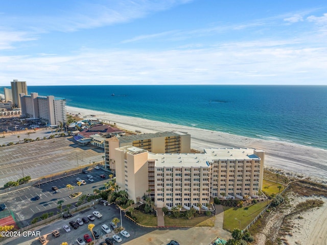 drone / aerial view with a water view and a beach view