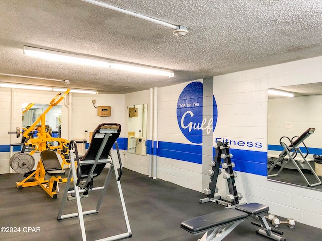 gym featuring a textured ceiling