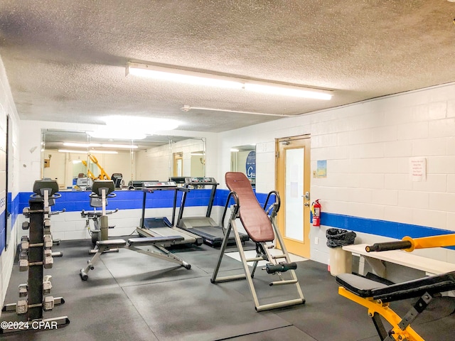 gym with a textured ceiling