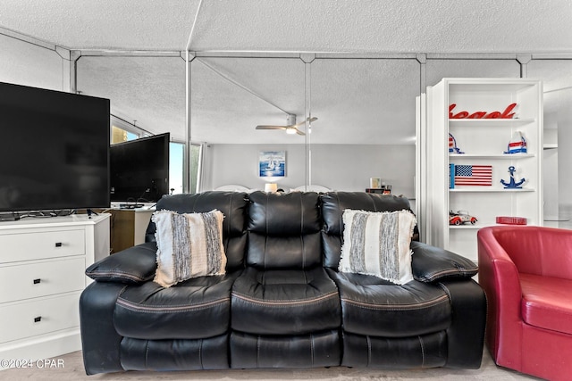 living room featuring a textured ceiling and ceiling fan