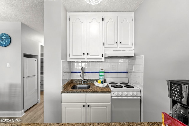 kitchen featuring white cabinets, white appliances, light hardwood / wood-style floors, and sink