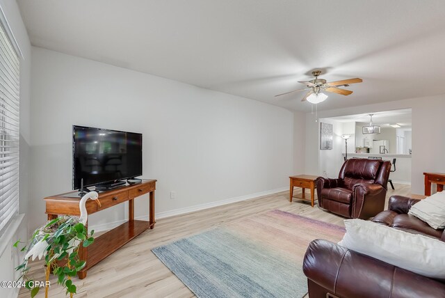 living room featuring ceiling fan and light hardwood / wood-style floors