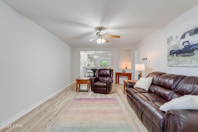 living room featuring ceiling fan and light hardwood / wood-style floors