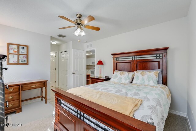 bedroom with ceiling fan and light carpet