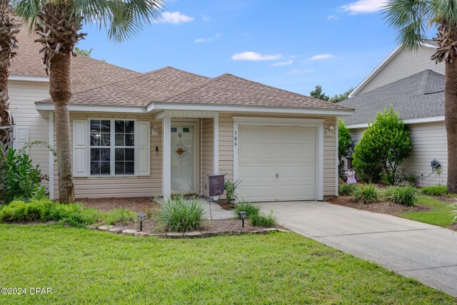 view of front of house with a front yard and a garage