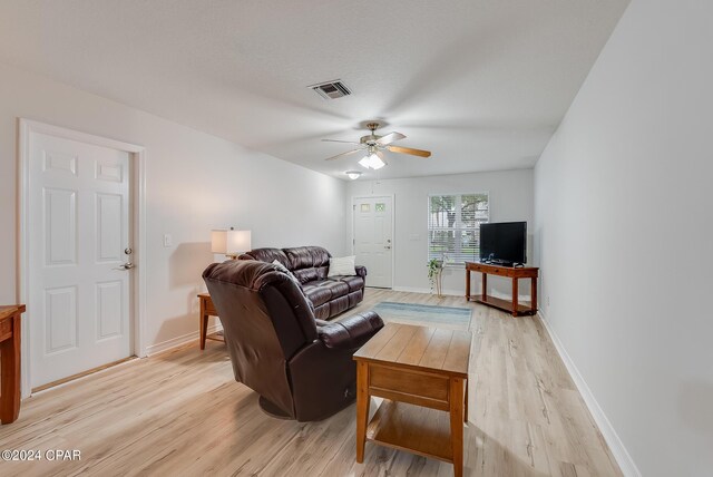 living room with ceiling fan and light wood-type flooring