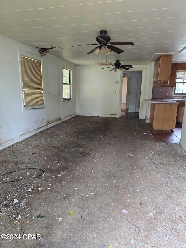 unfurnished living room featuring ceiling fan