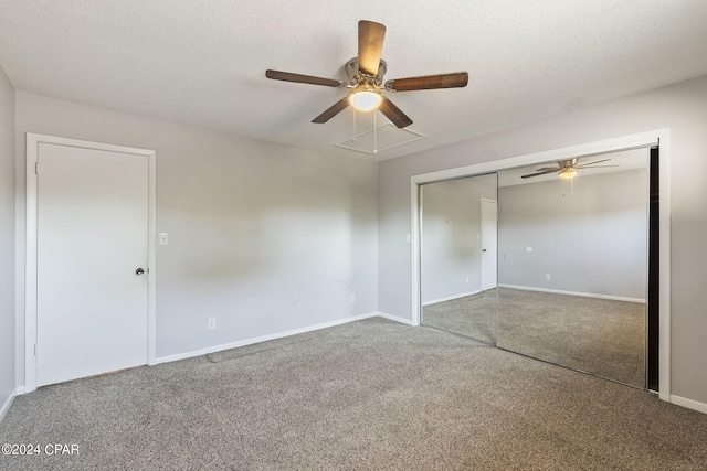 unfurnished bedroom featuring a textured ceiling, ceiling fan, a closet, and carpet floors