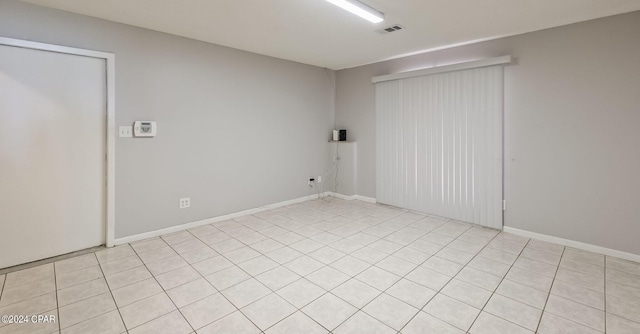 unfurnished room with light tile patterned floors