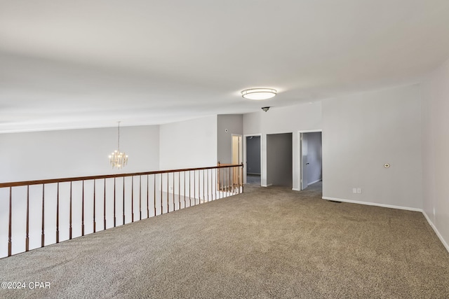 unfurnished room featuring carpet floors and a chandelier