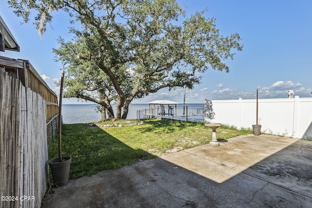 view of yard featuring a water view and a patio