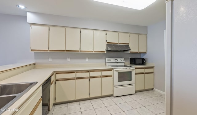 kitchen featuring black appliances, light tile patterned floors, and cream cabinetry