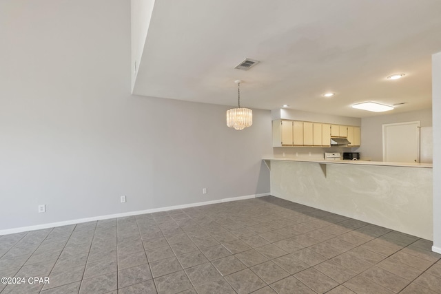 unfurnished living room featuring a notable chandelier and tile patterned flooring