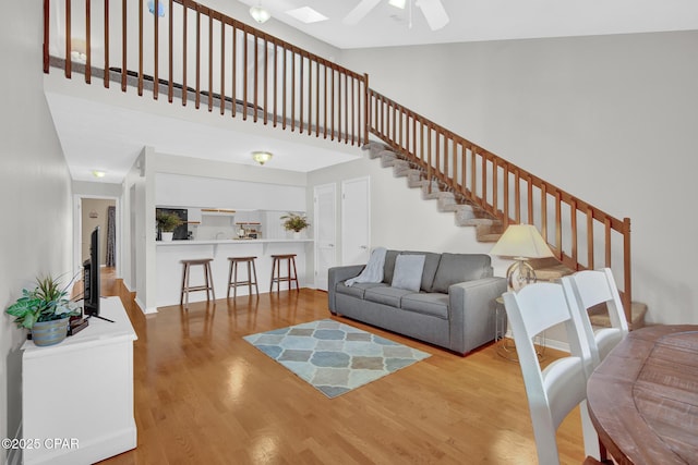 living room with wood-type flooring and ceiling fan